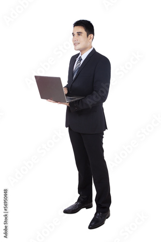 Photo: Businessman using laptop isolated on white Businessman using laptop isolated on white