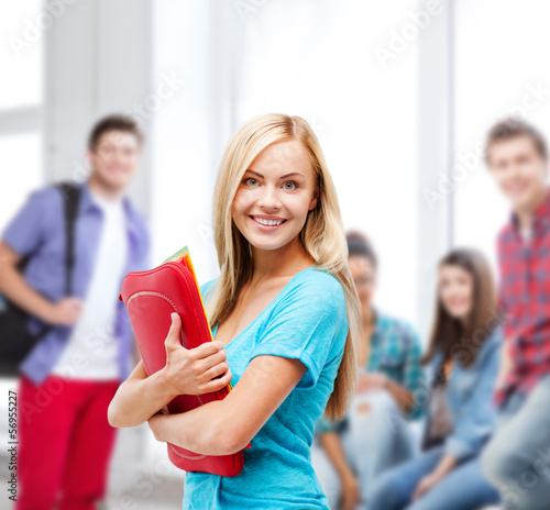 Photo: smiling student with folders smiling student with folders