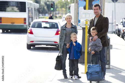 Photo: Family in city street with bags Family in city street with bags