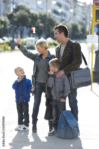 Photo: Family in city street with bags Family in city street with bags