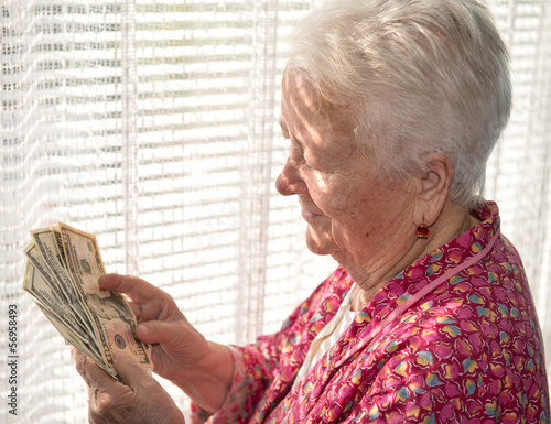 Photo: old woman holding money in hands old woman holding money in hands