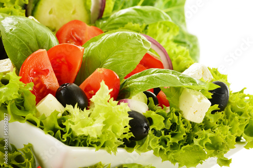 Photo: Vegetable salad bowl isolated on white Vegetable salad bowl isolated on white