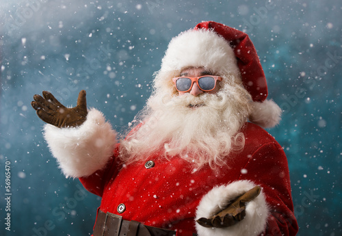 Photo: Santa Claus wearing sunglasses dancing outdoors at North Pole Santa Claus wearing sunglasses dancing outdoors at North Pole