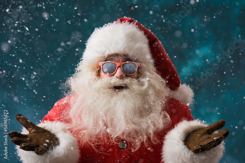Photo: Santa Claus wearing sunglasses dancing outdoors at North Pole Santa Claus wearing sunglasses dancing outdoors at North Pole