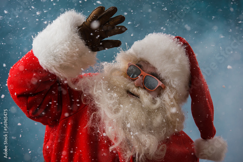 Photo: Santa Claus wearing sunglasses dancing outdoors at North Pole Santa Claus wearing sunglasses dancing outdoors at North Pole