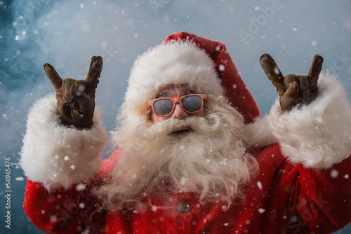 Photo: Santa Claus wearing sunglasses dancing outdoors at North Pole Santa Claus wearing sunglasses dancing outdoors at North Pole