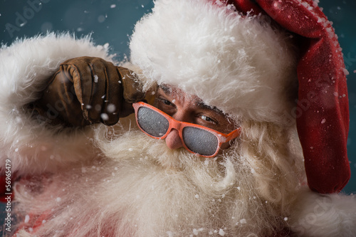 Photo: Santa Claus wearing sunglasses dancing outdoors at North Pole Santa Claus wearing sunglasses dancing outdoors at North Pole