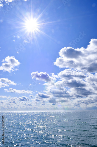 Photo: Blue water and sunny sky background Blue water and sunny sky background