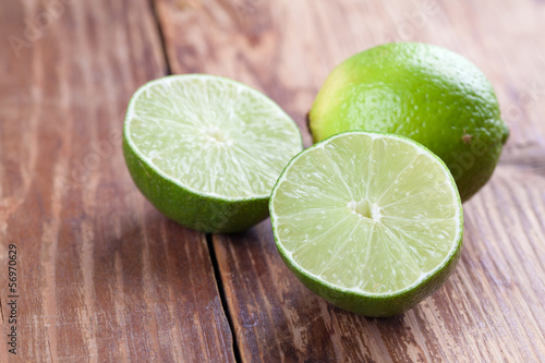 Photo: Limes on wood background Limes on wood background
