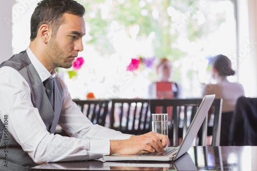 Photo: Concentrated businessman working on laptop Concentrated businessman working on laptop