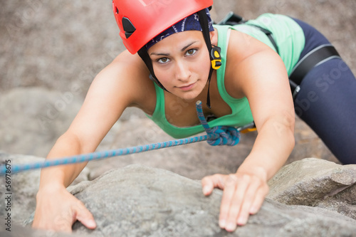 Photo: Focused girl climbing rock face Focused girl climbing rock face
