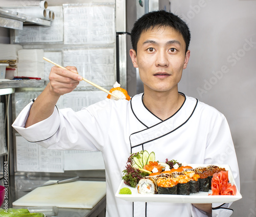 Photo: Japanese chef with a plate of sushi Japanese chef with a plate of sushi