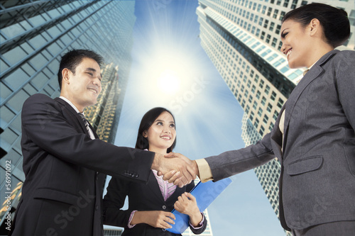Photo: Business people congratulating for the new partnership Business people congratulating for the new partnership