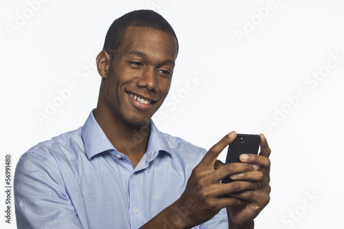 Photo: Young African American man texting, horizontal Young African American man texting, horizontal