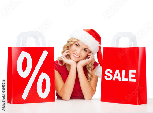 Photo: woman in red dress with shopping bags woman in red dress with shopping bags