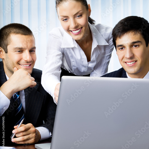 Photo: Businesspeople working with laptop at office Businesspeople working with laptop at office