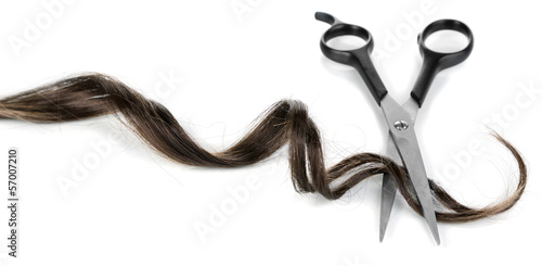 Photo: Shiny brown curl with scissors isolated on white Shiny brown curl with scissors isolated on white