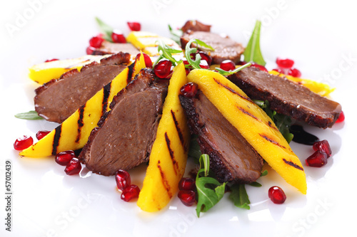 Photo: Salad with duck fillet and grilled mango on white background. Salad with duck fillet and grilled mango on white background.