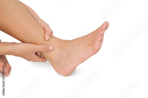 Photo: Close up of woman touching her injured foot Close up of woman touching her injured foot