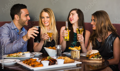 Photo: Friends having dinner together and toasting Friends having dinner together and toasting