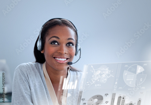 Photo: Cheerful woman with headset using futuristic interface hologram Cheerful woman with headset using futuristic interface hologram