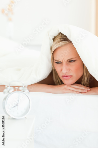 Photo: Portrait of a disgruntled woman waking up Portrait of a disgruntled woman waking up