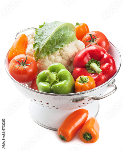 Photo: colorful vegetables in colander isolated colorful vegetables in colander isolated