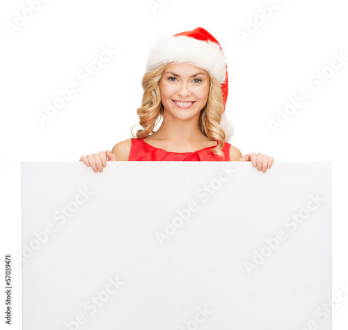 Photo: woman in santa helper hat with blank white board woman in santa helper hat with blank white board