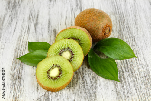 Photo: Ripe kiwi on wooden table close-up Ripe kiwi on wooden table close-up