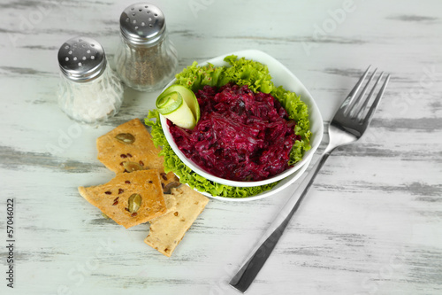 Photo: Beet salad in bowls on wooden table Beet salad in bowls on wooden table