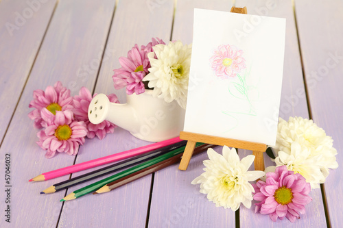 Photo: Composition of flowers and small easel with picture Composition of flowers and small easel with picture