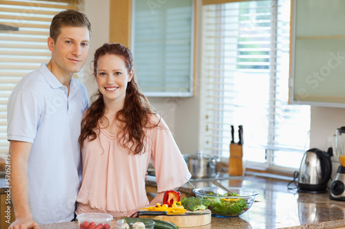 Photo: Couple standing behind kitchen counter Couple standing behind kitchen counter