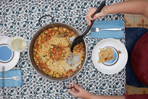 Photo: Woman's hands serving rice on a dish Woman's hands serving rice on a dish