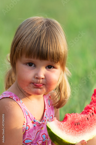 Photo: Portrait of the child who eats a sweet water-melon Portrait of the child who eats a sweet water-melon