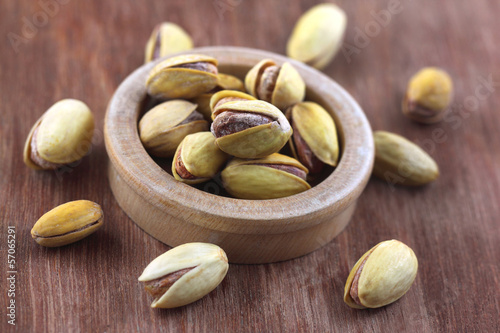 Photo: Pistachios on wooden surface Pistachios on wooden surface