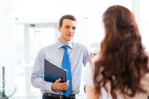 Photo: sales manager at a showroom car sales manager at a showroom car