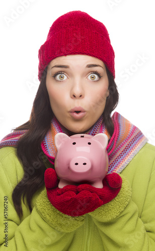 Photo: Expressive Mixed Race Woman Wearing Winter Hat Holding Piggybank Expressive Mixed Race Woman Wearing Winter Hat Holding Piggybank