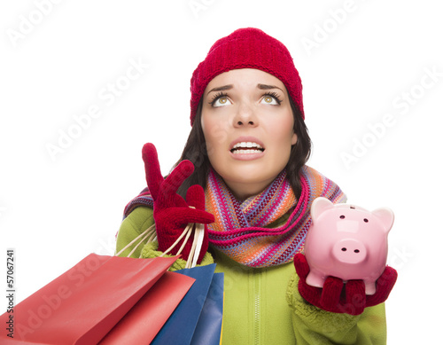 Photo: Stressed Mixed Race Woman Holding Shopping Bags and Piggybank Stressed Mixed Race Woman Holding Shopping Bags and Piggybank