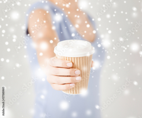 Photo: woman hand holding take away coffee cup woman hand holding take away coffee cup
