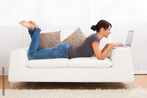 Photo: Beautiful Young Woman On A Sofa Beautiful Young Woman On A Sofa