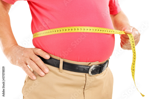 Photo: Fat mature man measuring his belly with measurement tape Fat mature man measuring his belly with measurement tape