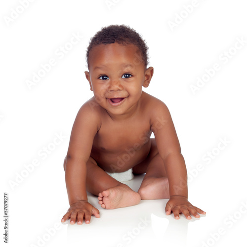 Photo: Adorable african baby in diaper sitting on the floor Adorable african baby in diaper sitting on the floor