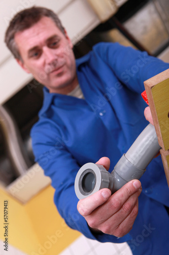 Photo: Plumber preparing plastic pipe Plumber preparing plastic pipe