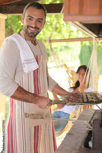 Photo: Man preparing kebabs on bbq Man preparing kebabs on bbq