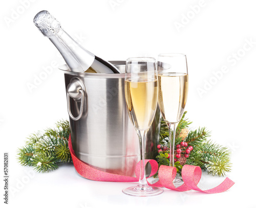 Photo: Christmas champagne bottle in bucket, glasses and fir tree Christmas champagne bottle in bucket, glasses and fir tree