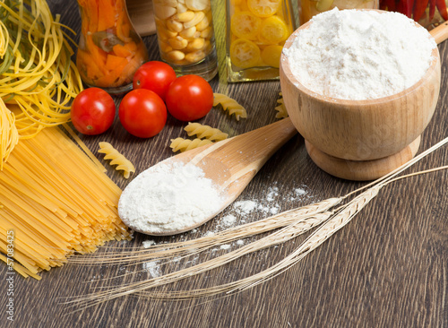Photo: pasta, tomatoes and flour on the spoon pasta, tomatoes and flour on the spoon