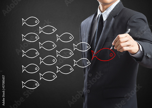 Photo: Businessman drawing fishes in group leadership concept Businessman drawing fishes in group leadership concept