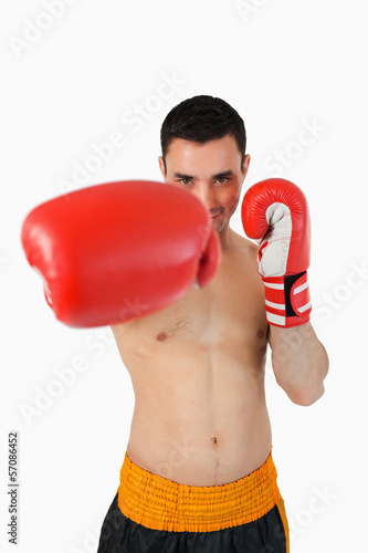 Photo: Smiling boxer attacking with his right fist Smiling boxer attacking with his right fist