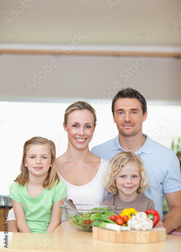 Photo: Family standing behind kitchen counter Family standing behind kitchen counter