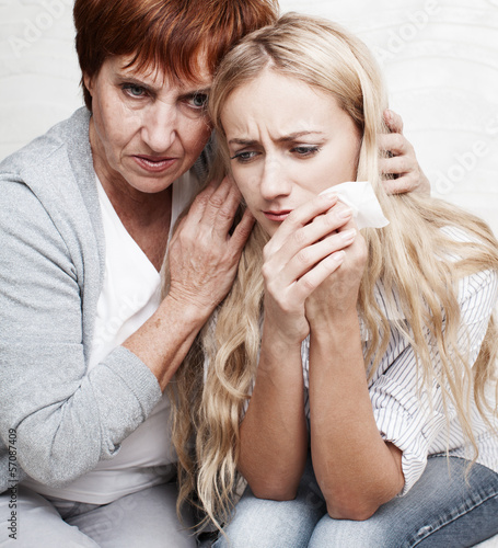 Photo: Mother soothes crying daughter Mother soothes crying daughter